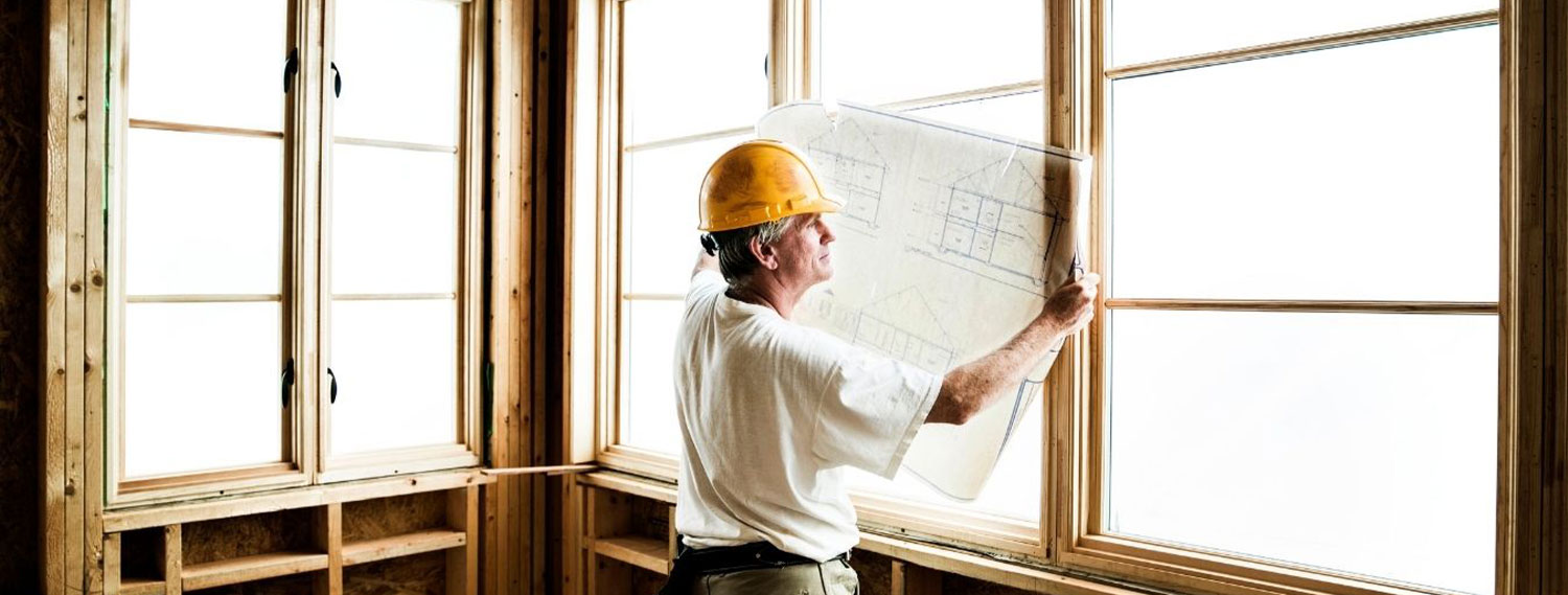 A man looking at house blueprints.